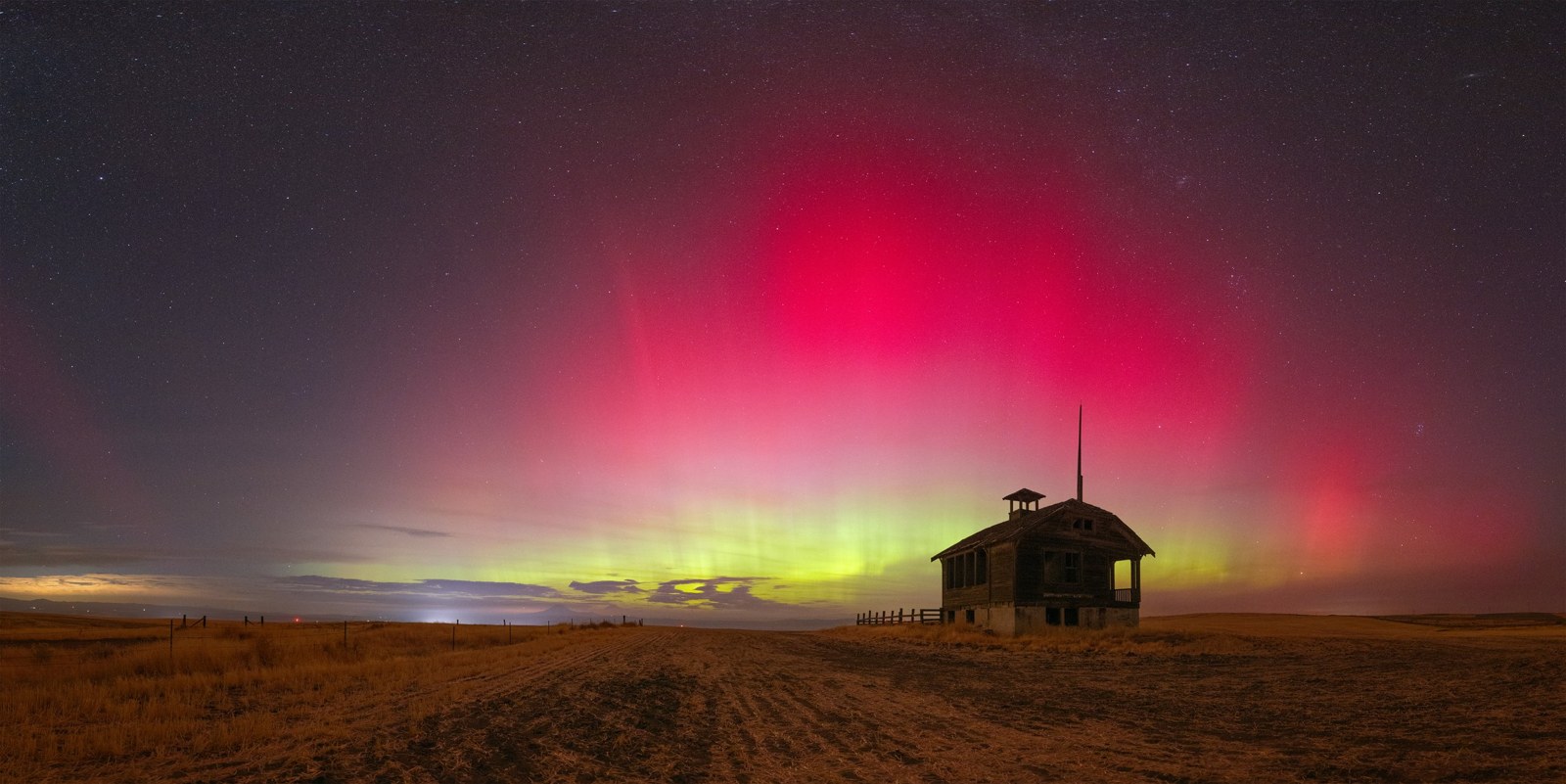 Red aurora over schoolhouse