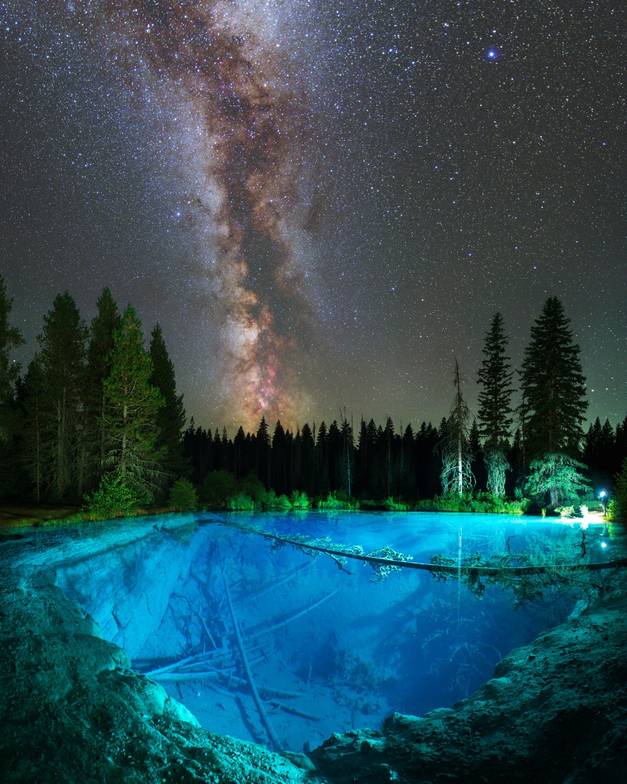 Milky way over illuminated little crater lake